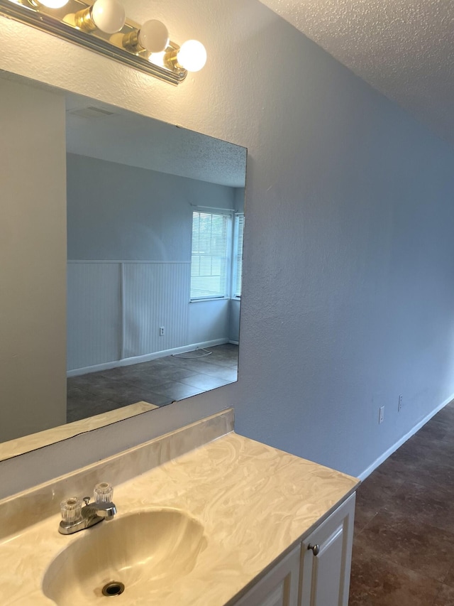 bathroom featuring vanity and a textured ceiling