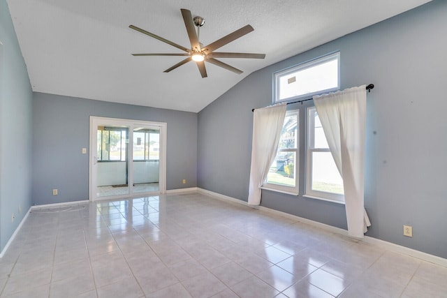 tiled empty room featuring ceiling fan, a textured ceiling, and vaulted ceiling