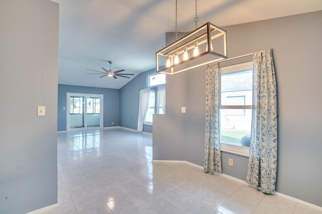 tiled spare room with ceiling fan with notable chandelier and lofted ceiling