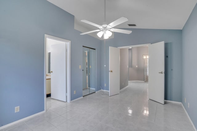 unfurnished bedroom featuring high vaulted ceiling, ensuite bath, ceiling fan, light tile patterned floors, and a closet