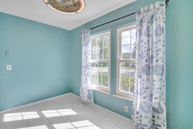 spare room featuring light tile patterned floors