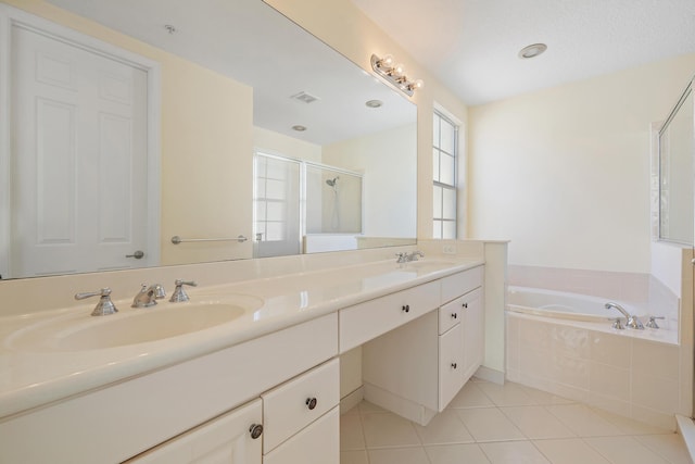 bathroom featuring shower with separate bathtub, tile patterned floors, and vanity