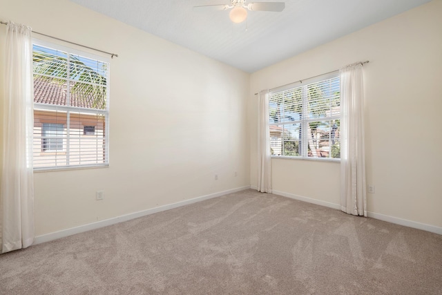 carpeted empty room featuring ceiling fan