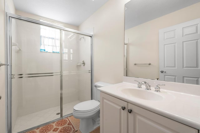 bathroom with a shower with door, tile patterned floors, toilet, and vanity