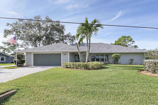 single story home featuring a garage and a front yard