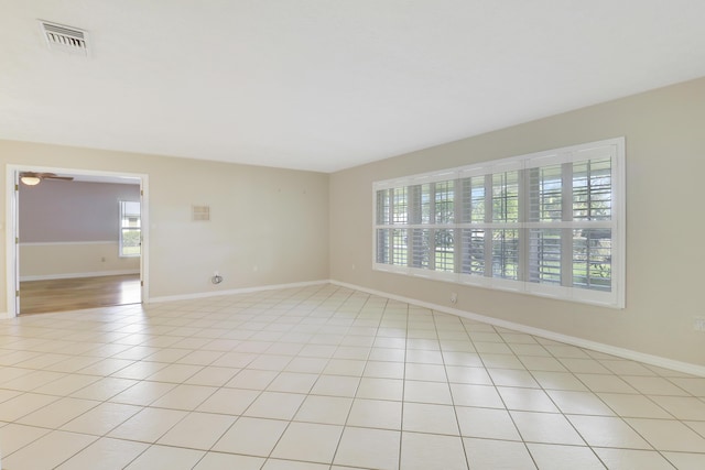 unfurnished room featuring light tile patterned floors and plenty of natural light