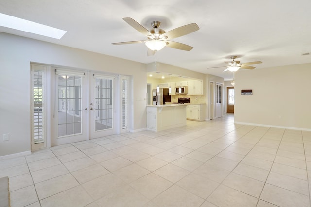 unfurnished living room featuring ceiling fan, french doors, and light tile patterned floors