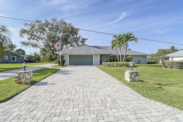 ranch-style home with a garage and a front lawn