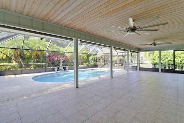 view of swimming pool featuring a lanai, a patio area, and ceiling fan