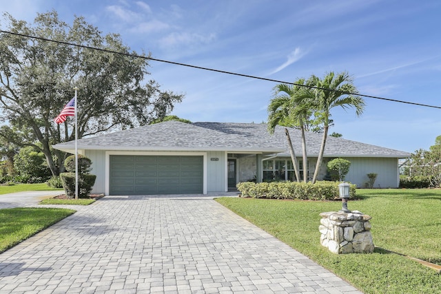 ranch-style house with a front yard and a garage