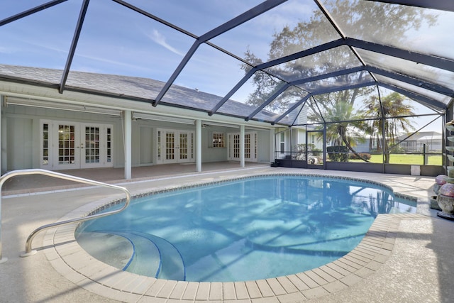 view of swimming pool with a lanai, a patio, and french doors