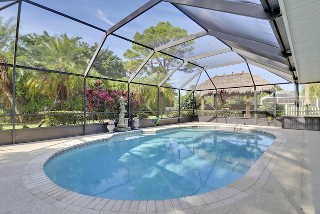 view of swimming pool with glass enclosure