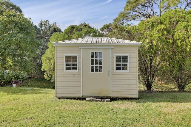 view of outbuilding with a lawn