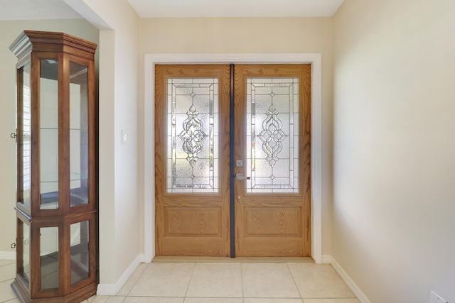 entryway with french doors and light tile patterned floors