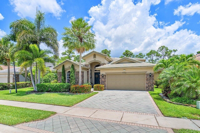 view of front facade with a front yard and a garage