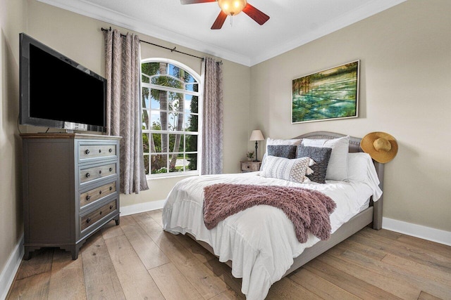 bedroom featuring hardwood / wood-style flooring, ceiling fan, and ornamental molding