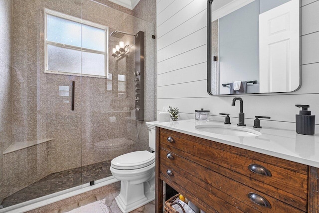 bathroom featuring walk in shower, vanity, wooden walls, crown molding, and toilet