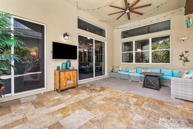 view of patio with an outdoor living space and ceiling fan