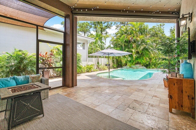 view of swimming pool featuring a patio and an outdoor fire pit