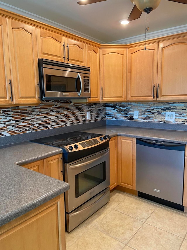 kitchen featuring stainless steel appliances, tasteful backsplash, crown molding, and light tile patterned flooring