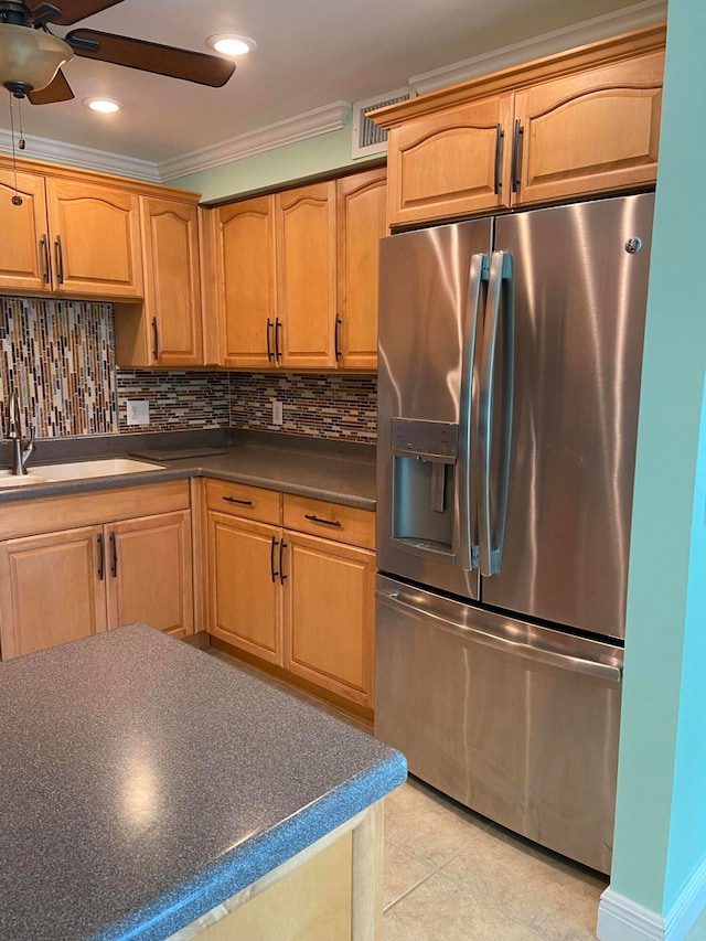 kitchen featuring backsplash, sink, ornamental molding, light tile patterned flooring, and stainless steel fridge with ice dispenser