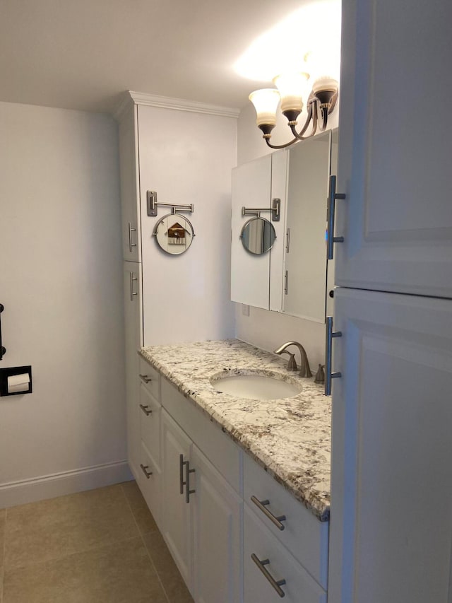 bathroom featuring tile patterned floors, vanity, and a notable chandelier