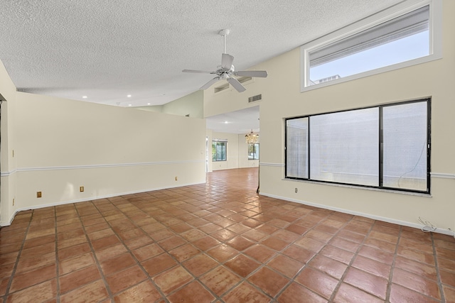 tiled empty room with a textured ceiling, ceiling fan with notable chandelier, and high vaulted ceiling