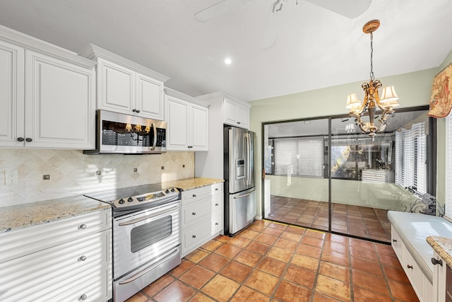 kitchen featuring a wealth of natural light, appliances with stainless steel finishes, backsplash, and white cabinetry