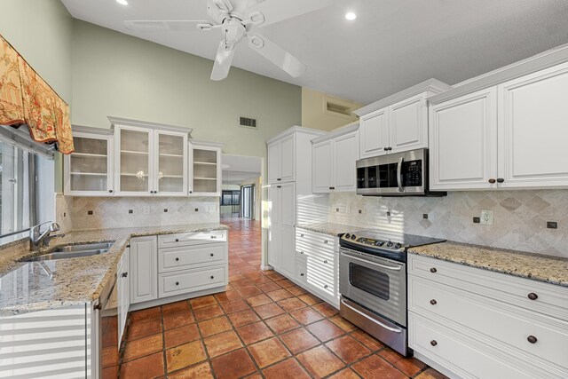 kitchen featuring ceiling fan, white cabinets, appliances with stainless steel finishes, and sink