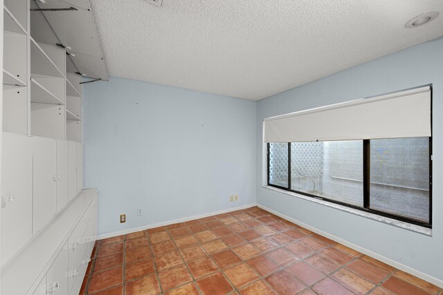 empty room with a textured ceiling