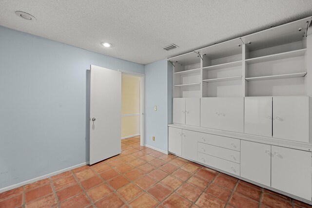 unfurnished bedroom featuring a textured ceiling