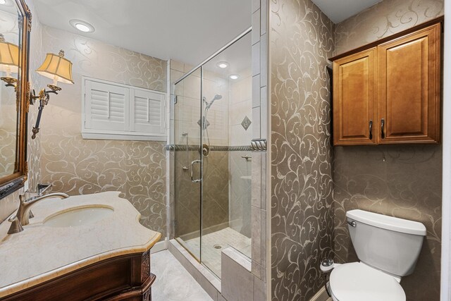 bathroom with toilet, vanity, and walk in shower