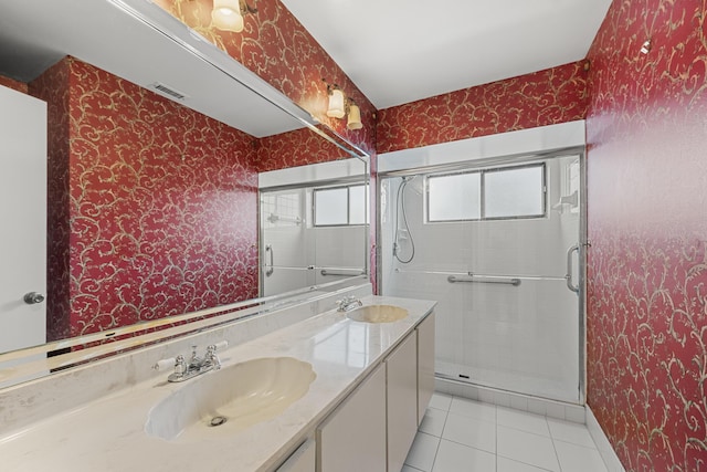 bathroom featuring vanity, tile patterned flooring, and a shower with door