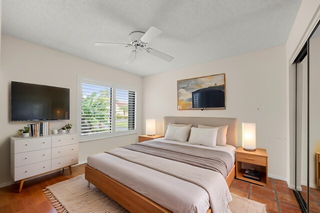 bedroom featuring ceiling fan, a closet, and hardwood / wood-style flooring