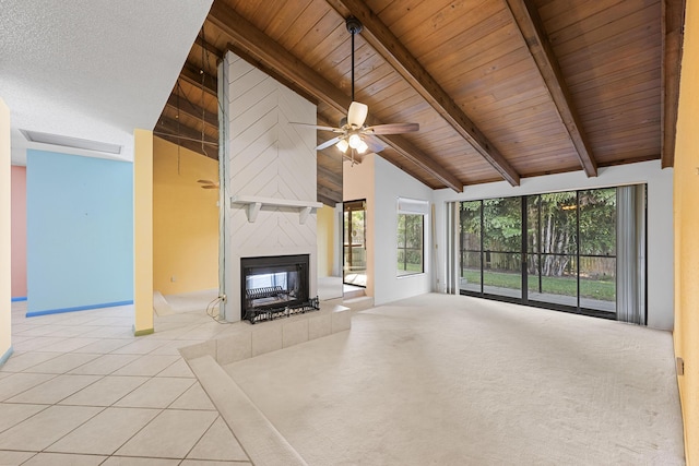 unfurnished living room featuring high vaulted ceiling, ceiling fan, a fireplace, beamed ceiling, and wood ceiling