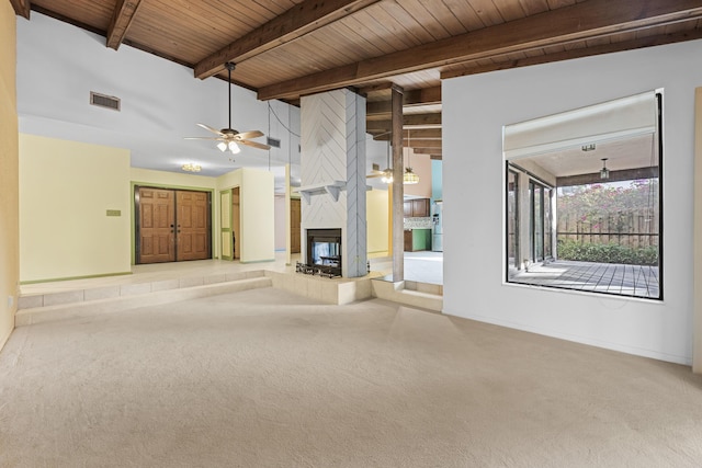 unfurnished living room with wood ceiling, light colored carpet, ceiling fan, lofted ceiling with beams, and a tiled fireplace