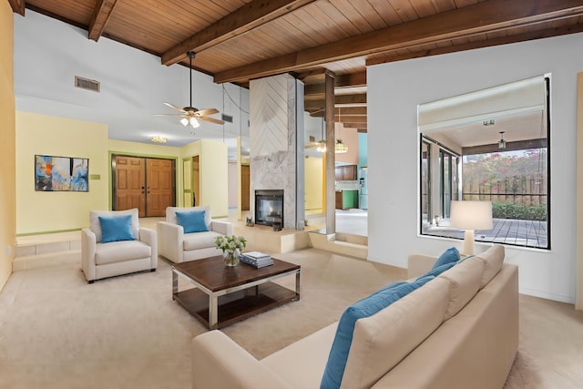 living room with lofted ceiling with beams, a fireplace, and wooden ceiling