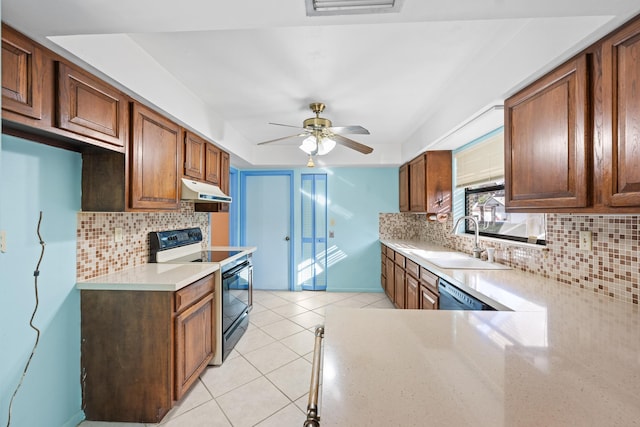 kitchen with a raised ceiling, ceiling fan, sink, light tile patterned floors, and black range with electric stovetop