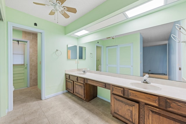 bathroom with ceiling fan and vanity