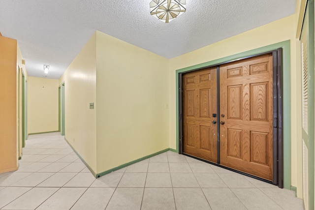 tiled foyer entrance featuring a textured ceiling