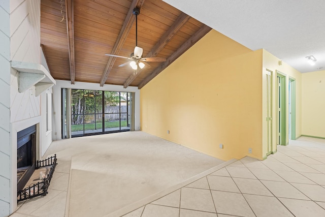 unfurnished living room with lofted ceiling with beams, ceiling fan, wooden ceiling, and light tile patterned flooring