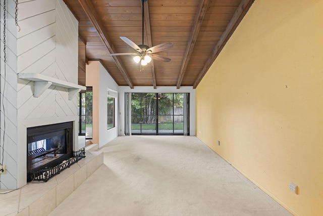 unfurnished living room featuring a tile fireplace, ceiling fan, wooden ceiling, lofted ceiling with beams, and light carpet