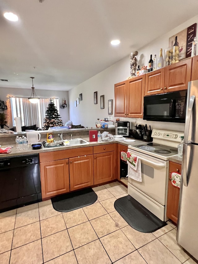 kitchen with light tile patterned floors, black appliances, brown cabinets, and a sink