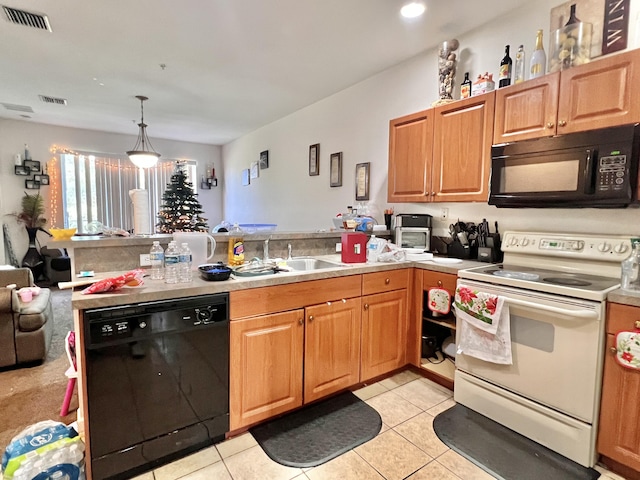 kitchen with a sink, a peninsula, black appliances, visible vents, and light tile patterned floors
