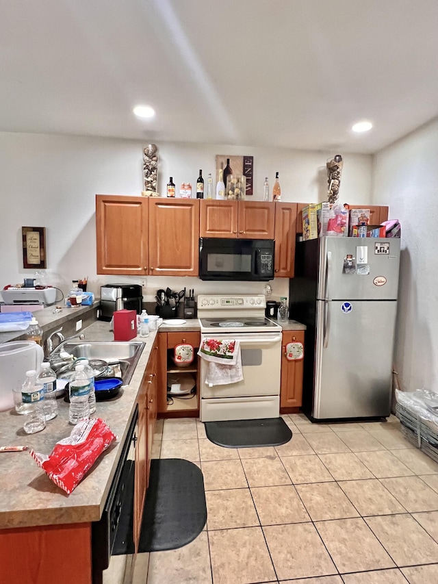 kitchen featuring a sink, freestanding refrigerator, black microwave, white electric range oven, and light tile patterned floors