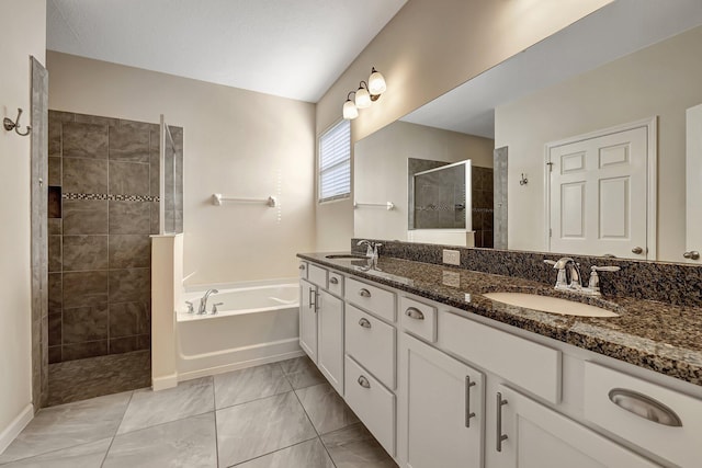 bathroom featuring vanity and independent shower and bath