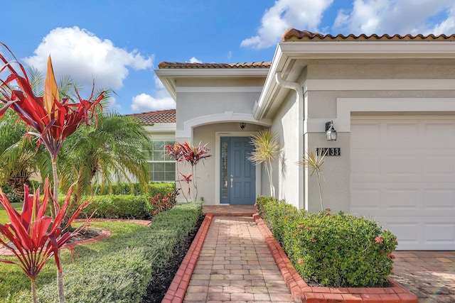 view of exterior entry with a garage