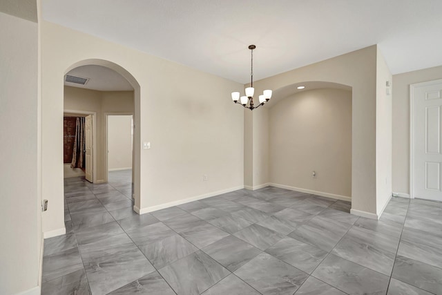 empty room featuring a notable chandelier