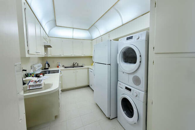 washroom featuring sink and stacked washer / dryer