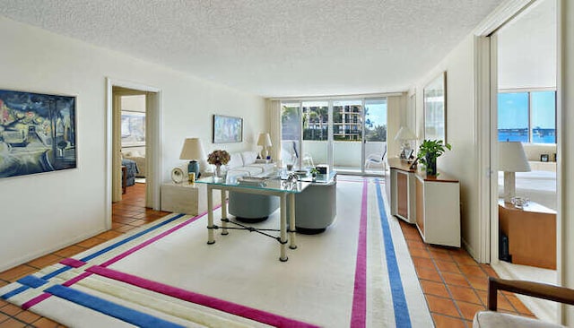 living room featuring tile patterned flooring and a textured ceiling